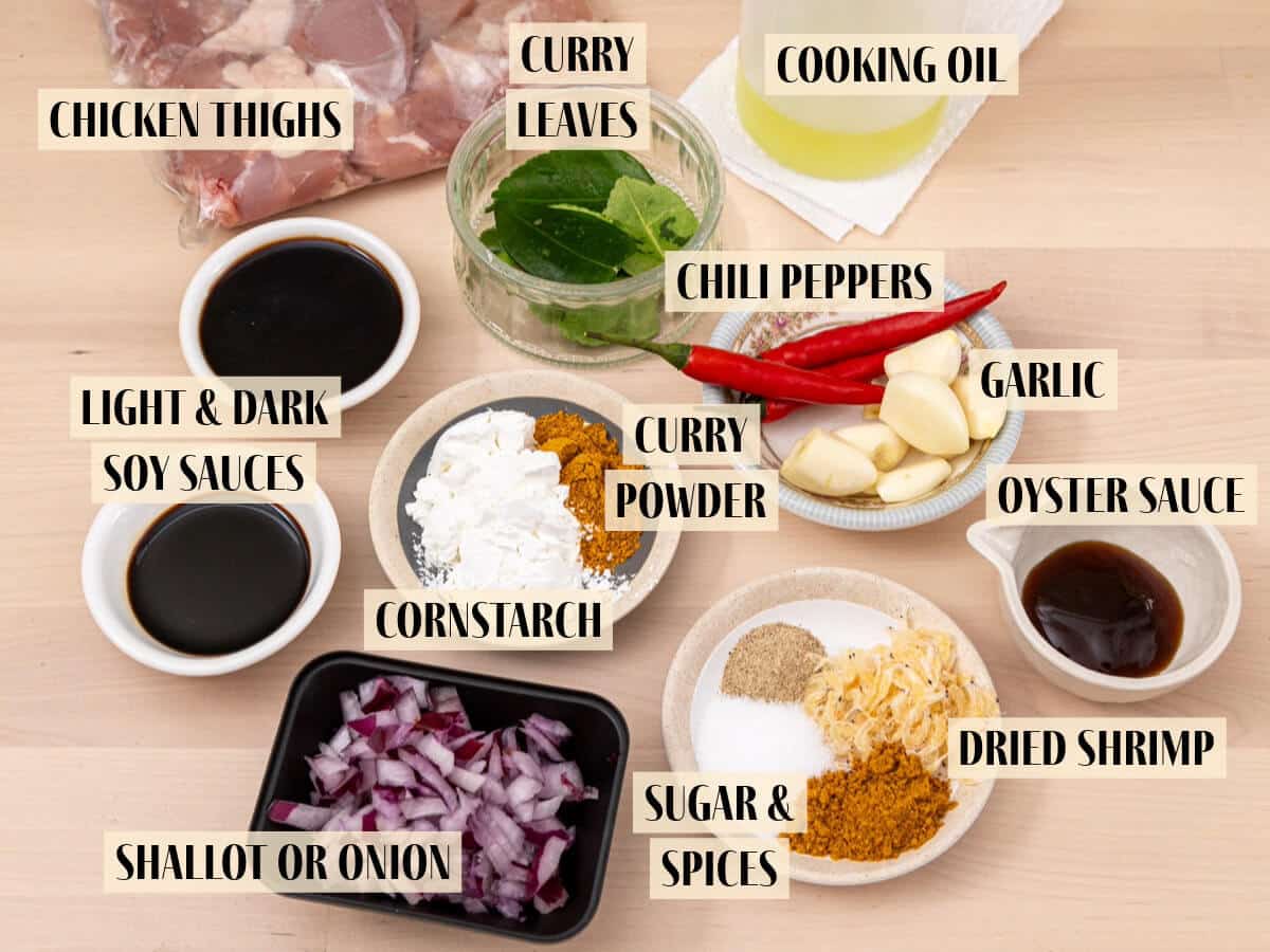 Ingredients for kam heong chicken on a wooden table.